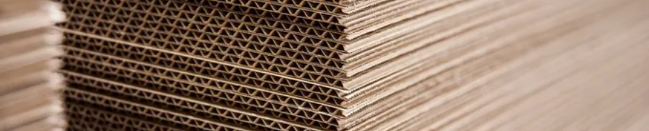 A stack of corrugated sheets showing the flute layers from the side